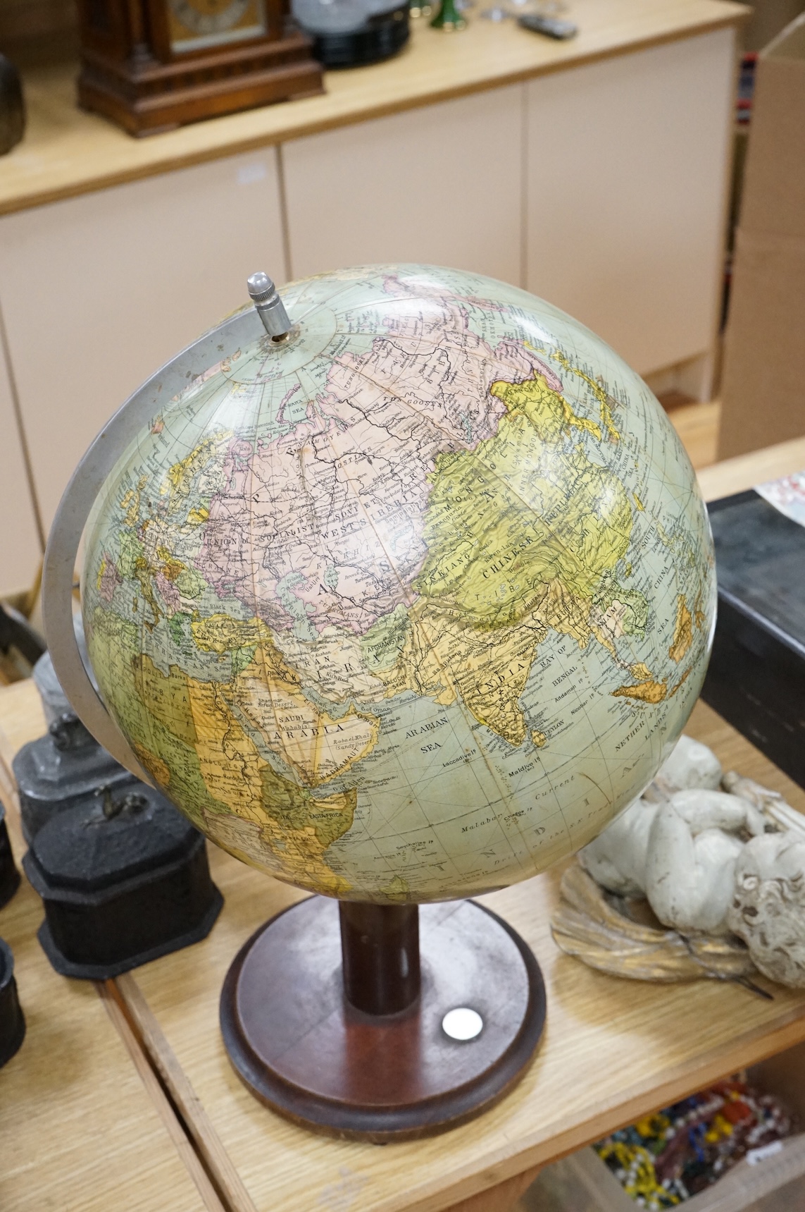 A vintage revolving globe with inset compass to the base, 55cm high